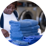 Laundromat Attendant Folding Blue Towels Min